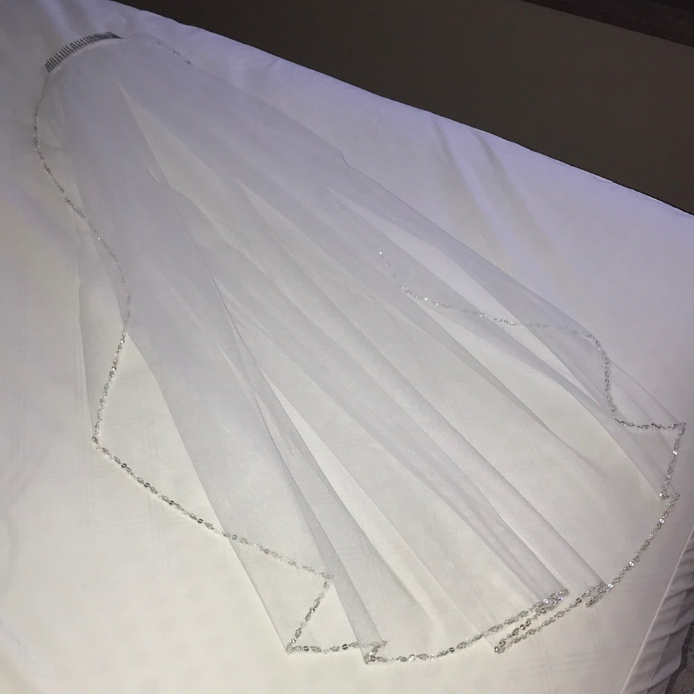 Sleek medium length white veil with beaded trim